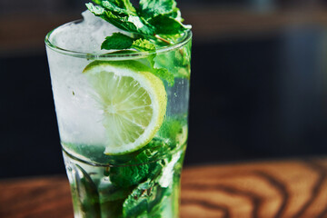 Close up view of fresh summer non alcoholic mojito cocktail on the wooden table
