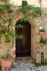 Old house with wooden door in Volterra, tuscany, italy