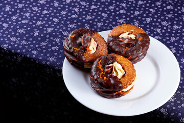 Three yummy homemade chocolate covered marshmallow crackers on white plate on a purple napkin