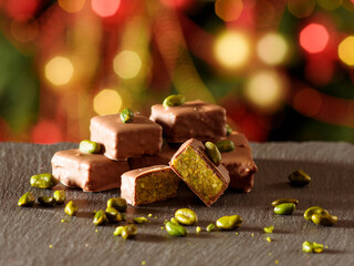 Chocolate candies with pistachio filling  taken on the New Year's table  in the section. Handmade