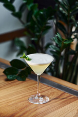 Green mint and yellow lime. Close up view of fresh summer cocktail on the wooden table