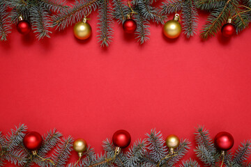 Christmas decorations and fir tree on red background