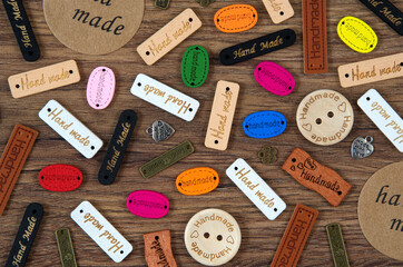 Colored handmade tags on a wooden background