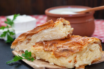 Homemade Traditional Serbian Gibanica with cheese. Delicious soft cheese pie, cut and layed on...
