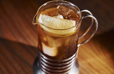 Ice cubes inside. Close up view of fresh summer cocktail on the wooden table