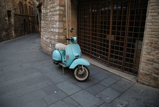 An old scooter in a street of Assisi, Italy