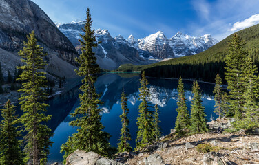 Magnificent scenery of beautiful lake with clean plain water reflecting rocky mountains and green forest in sunny day in Duffey Lake Provincial Park in Canada