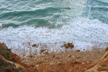 Foamy waves and brown rocks