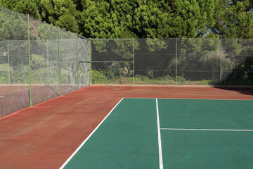Empty Tennis Court. Green trees on a background
