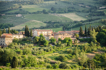 Fototapeta premium A castle on top of a lush green field. Tuscany, Italy.