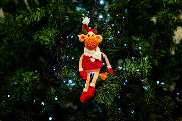 Christmas bull toy Santa sitting on the green Christmas tree