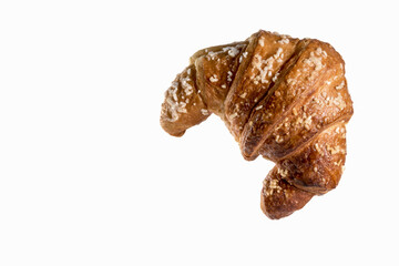 Fragrant croissant with glazed sugar sprinkles. Typical French brioche for breakfast, isolated on white