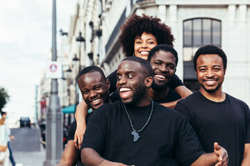 Happy black race friends hanging out in the city in a summer day.