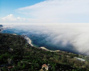 City in fog. Aerial view of the city. fog over the city, sea and park. Residential buildings in the fog.