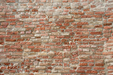 Naklejka premium Old red grungy brick wall gives a harmonic structure