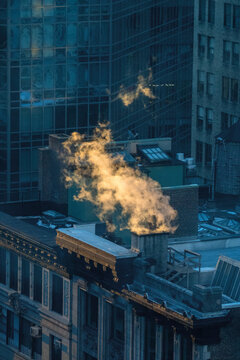 Steam Rising Out Of Building On A Cold Morning.