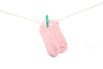 sock hanging on a rope with clothespins isolated on white background