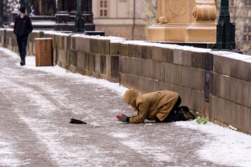 Prague, Czech Republic: Beggar begging for alms on the street in Prague