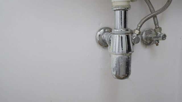 broken leaking pipe under the sink