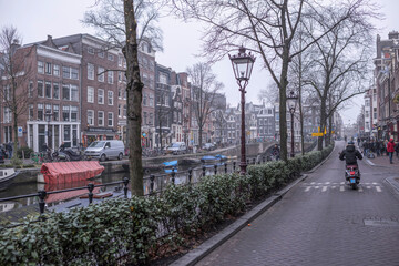  Amsterdam.  In the streets of the ancient city tourists move and transport