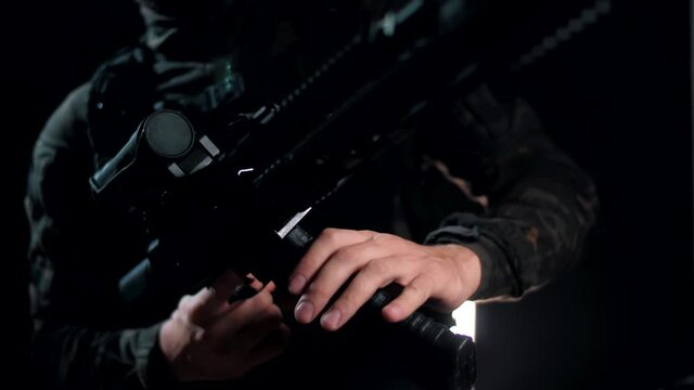 Man in the multicam attaches the store to the AK