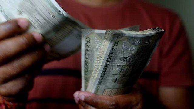 India men counting Indian currency
