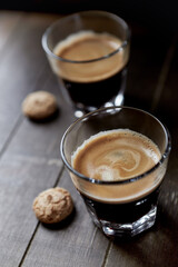 Two Glasses Of Coffee on dark wooden background. Close up. 