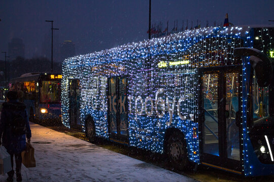 Moscow, Russia - January 2020: An electric bus (electrobus) decorated with New Year garlands in the evening on the streets of Moscow