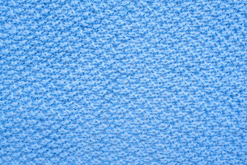 Blue knitted scarf texture background top view.