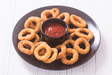 Crunchy fried onion rings and ketchup