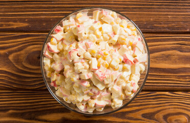 Salad with crab sticks , corn , eggs and mayonnaise