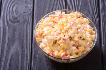 Salad with crab sticks , corn , eggs and mayonnaise