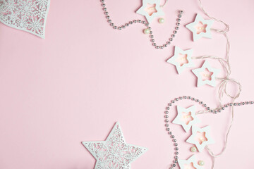 Festive pink background. Light pink background, garland with white stars. Christmas. Flatlay, top view, copy space.