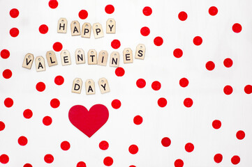 Valentines red shape of heart and text with wooden letters on white background. Greeting card, banner