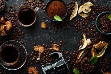 Mushroom Chaga Coffee Superfood, trendy drink on a black stone background. Top view. Free space for text.