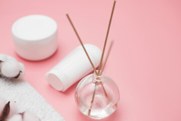 spa concept, cotton white jars on a pink background, copy space, top view