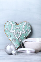 Vintage Christmas ornament (heart shaped). Wooden background. Close up.