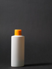 White tube bottle of shampoo, conditioner, hair rinse, mouthwash, on a colored background.
