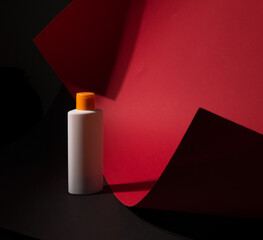White tube bottle of shampoo, conditioner, hair rinse, mouthwash, on a colored background.