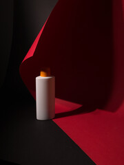 White tube bottle of shampoo, conditioner, hair rinse, mouthwash, on a colored background.