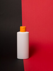 White tube bottle of shampoo, conditioner, hair rinse, mouthwash, on a colored background.