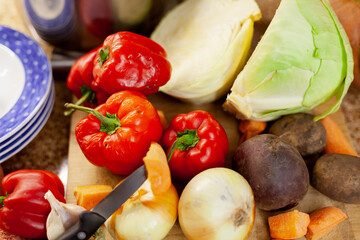 Set of vegetables and utensils on kitchen table