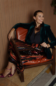 Stylish woman sitting on the chair and smiling