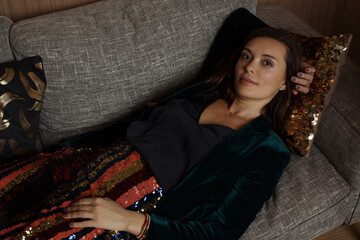 Beautiful woman in evening dress on the sofa