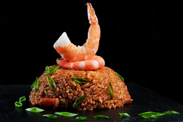 Rice with shrimps on black background