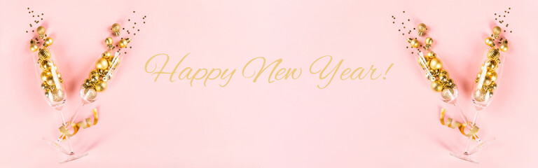 Christmas or New year greeting card.Decorated Bottle of Golden Champagne with glasses