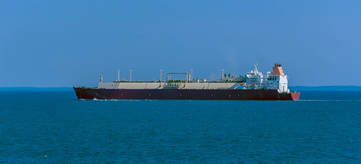 A large Liquid Natural Gas tanker ship approaching Singapore in summertime