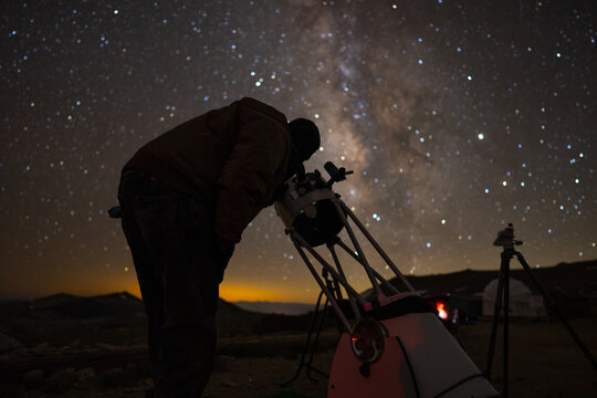 Amateur Astronomer Observing the Stars with a Telescope