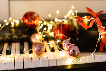 Piano keys with Christmas decorations, closeup