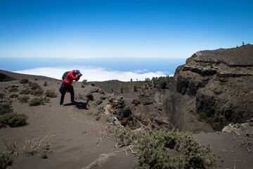 man hiking and photographing volcanic nature on canary islands